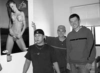 Kyle and buddies hang out next to a poster that is NOT Kyle's.