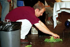 College Union Building guy and SPOT advisor Brian Kennedy uses some lettuce as a barrier to pick up some of the spilled muck.