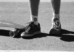 Required equipment:  Randy Smith displays his mismatched footwear.  One shoe has a thicker sole to act as brakes after a run. / Photo by Missy Votel