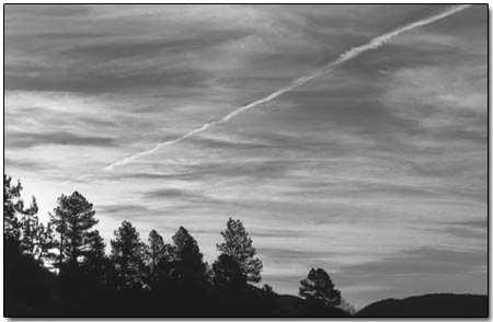 Jet contrails are seen crossing the evening sky in Durango on Sunday. A group of locals believes the contrails are actually harmful chemicals that are deliberately emitted by low-flying, unmarked planes as part of a covert government operation./Photo by Amy Maestas.
