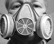 Clifford Carnicom,  a Santa Fe, N.M., computer consultant, often wears a ventilator mask when venturing outside to protect himself from deadly chemicals that he believes are released into the air./Photo courtesy Clifford Carnicom.
