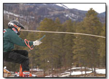 Skier Aaron Cisco concentrates on holding onto his rings as he exits the first jump.