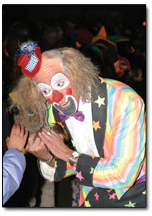 A clown entertains a young group of Snowdown partiers.