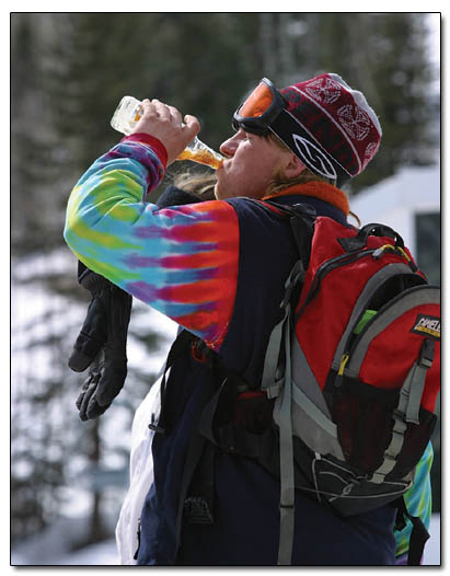 Eric Williams, of Farmington, chugs the remainder of his beer before heading back to the slopes.