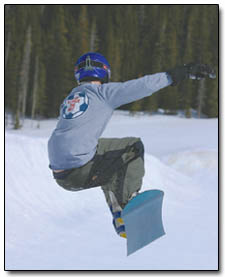 A snowboarder enjoys the warm weather and soft snow in the half-pipe this past weekend.