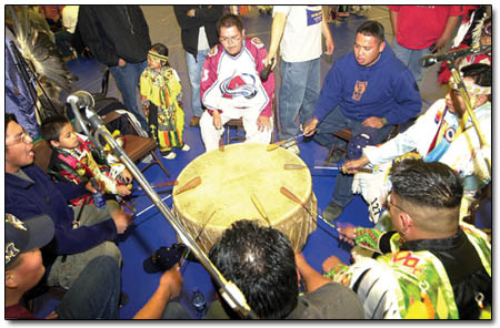 Talking Spirit, a family of drummers from Shiprock, takes a turn beating the drum at Friday’s pow-wow.