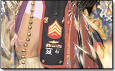 A dancer displays his Marine sergeant insignia on his costume.