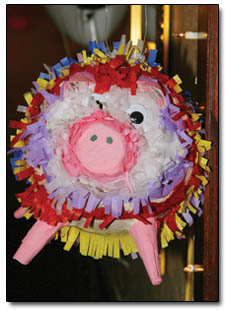 The mascot for Pigs-in-a-Blanket hangs outside the entrance to their roomful of pastry-wrapped sausages.