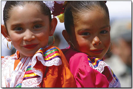 10 year-old Juanita Moreno, left, and 10 year-old Flor Chacon, both of Durango, Colo., enjoy the Cinco de Mayo entertainment prior to their mid-afternoon dance performance.