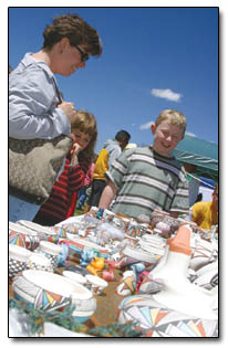 Monica Calvet and her children James and Grace admires pottery at one of the many booths.