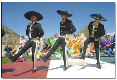 Three mariachi dancers entertain the crowd.