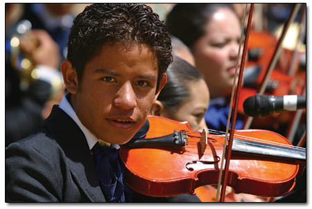 A violinist in La Escuela de Musica Mexicana helps contribute to the rich sound of the school's band.