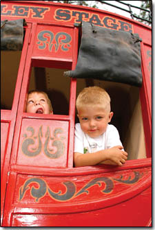Six-year-old Nashland Karter, left, and four-year-old Christopher Upton, of Aztex, play inside the Mancos Valley Stage Coach.