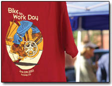 A Bike to Work Day T-shirt featuring the logo made by local artist Bryan Peterson, hangs from the booth of the Durango Cyclery.  T-shirts were on sale for $12.
