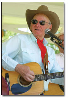 Cy Scarborough, of the Bar D Wranglers, strums his guitar during the group's performance.