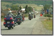 A group of motorcyclists exits the highway for a foray into Silverton on Sunday.