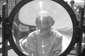 Through the looking glass: Katera Rogers, 10, of Durango, takes a look through a large magnifying glass at the Durango Arts Center booth. 