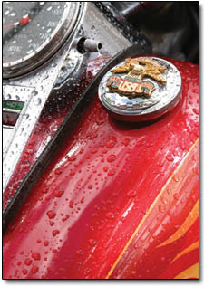 Rain droplets dot the gas tank of a motorcycle parked on Main Avenue after Saturday's thundershowers.