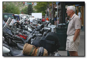 Tom Crosset, of Durango, surveys the collection of motorcycles parked along Main Avenue on Friday afternoon.