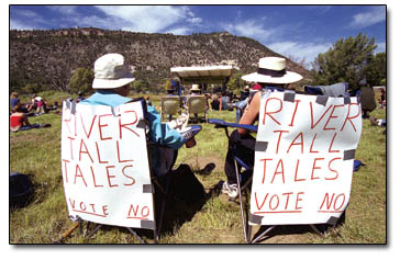 Roger and Jeanette Clifton use their lawn chairs to voice their view on the proposed River Trails Ranch, which is adjacent to the Animas Meanders Ranch.