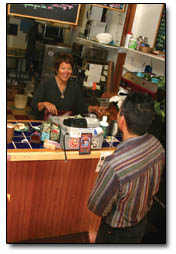 Cindi Scheridan, ownder of the Buzz House, greets Joe Quezada, a Buzz House regular, after the morning coffee rush.