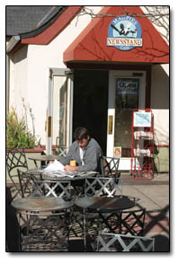 Tom Quirk catches up on local news outside Magpies on a warm fall morning last week.