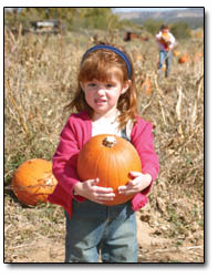 3 year-old Razzie Silva celebrates her birthday in the pumpkin patch with her brand new, soon-to-be jack-o-lantern.