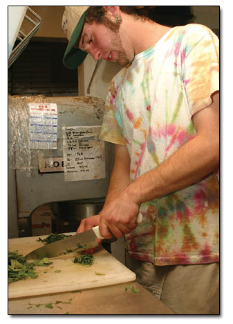 Paul Geoghan chops up frech basil at Homeslice.