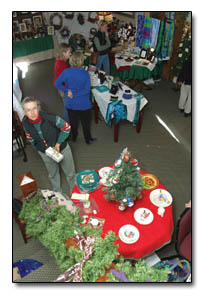 Holiday shoppers enjoy the season as they peruse the offerings on display by The Cottonwood Christmas Artisans at the Rochester Hotel.