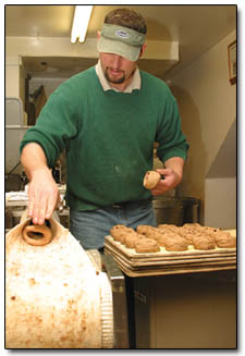 John Schwarz, owner of Durango Bagel, rolls a fresh batch of cinnamon  raisin bagels Monday afternoon.
