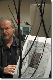 Chuck Reames passes a work by Mary Ellen Long titled "Remains, Missionary Ridge."