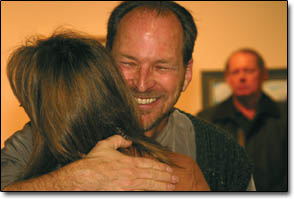 Arts Center Director Brian Wagner gets a hug from an artist during the awards ceremony Monday night.