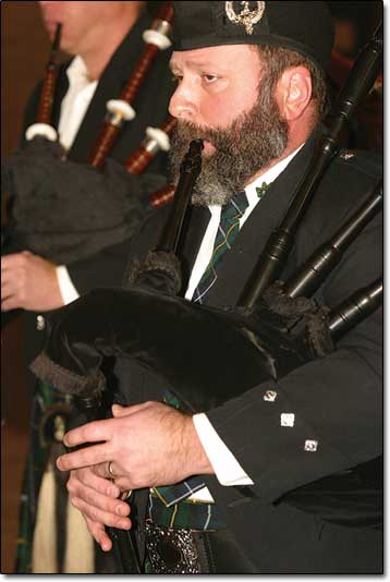 Jerry Crawford plays the bagpipes among his fellow members in the Westwind Pipe Band.