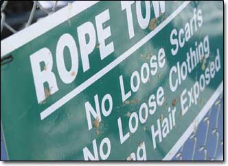 A sign warns riders of the potential deterrents to a smooth ride on the tow rope.
