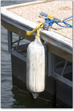 
  An unused buoy sways against the light waves pushing against the dock at the Durango Resort Marina.
