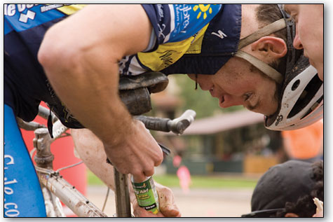 
  Daniel Murray, of Telluride, fastens a can of compressed air onto his frame before heading out on his final lap.
