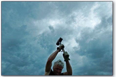  Mike Luther, of Silverton, raises his hammer toward the sky while competing in the two-man hand steeling competition.