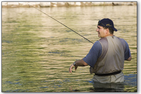 John Reiter watches his fly travel downstream during an evening
of fishing on the Animas with his brother.