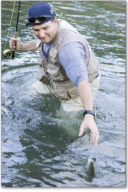 John Reiter hauls in a fish as dusk falls on the Animas.
 