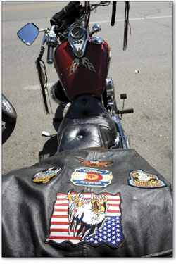 A biker's leather jacket sits on the back of his hog before the parade.