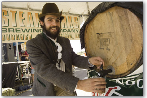 Peter Clevano draws a beer from the ceremonial keg of Carvers beer  shortly after things got under way Saturday.