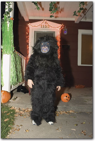 A gorilla takes a break from handing out candy in front of his home along E. Third Ave.
