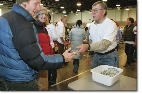 Bob Croll greets the hordes of ski enthusiasts as he collects the entrance fee Saturday morning.