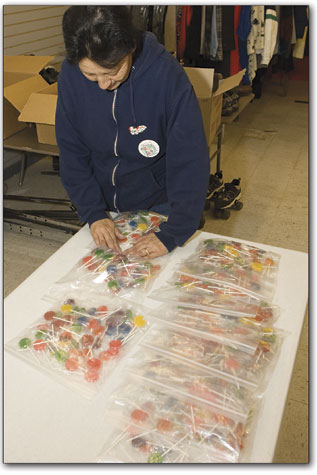 Nancy Smith packs up bags of lollipops to be distributed as a sweet holiday treat.