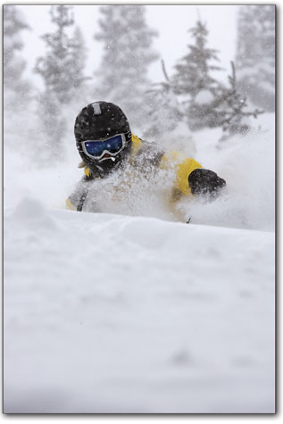 Jason Ebelheiser smiles beneath his helmet as he emerges from a
field of snow.