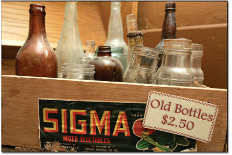 A box full of antique glass bottles sits above the Animas Museum
entrance.
