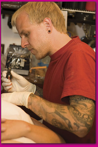 Thomas Kipp works on a client at his work station at Your Flesh
Tattooing.