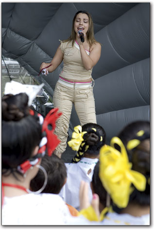 Ernestine Romero, known as La Jovencita, performs to a gathering
crowd Saturday.
