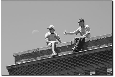 Zane Wells, left, and Robbie Lawson take in the Taste of Durango
from their elevated position above Main Avenue.