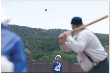 Duane Smith sends in a high pitch during the first inning of the
old-time baseball game last Saturday.